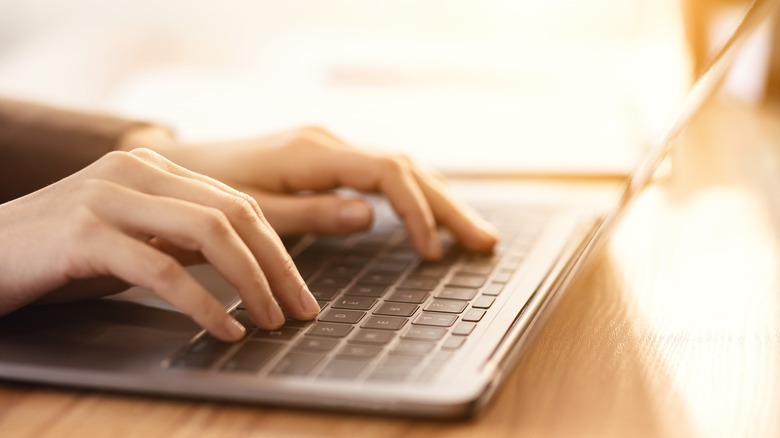 woman's fingers on keyboard