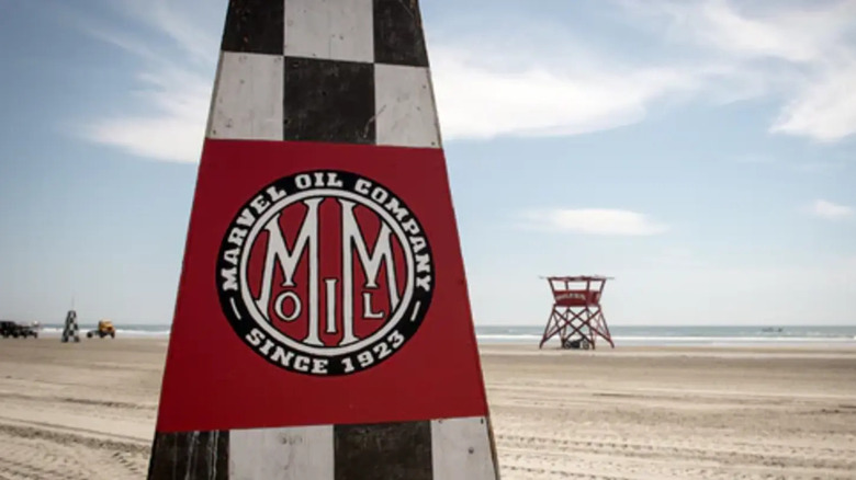 Marvel Mystery Oil sign on a beach