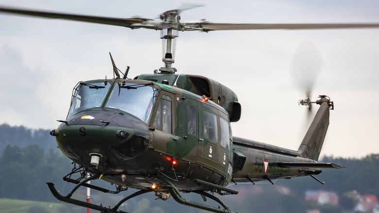An Austrian Air Force Agusta Bell AB-212 5D-HS flying on a cloudy day
