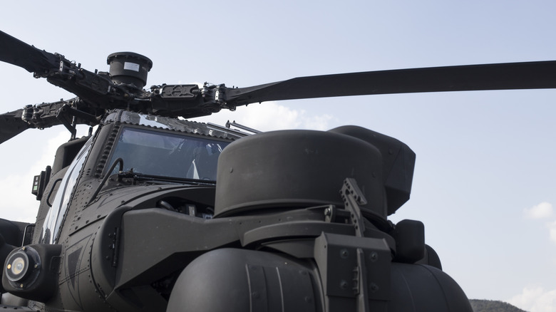 Close up of the rotor system and part of the body of a military helicopter