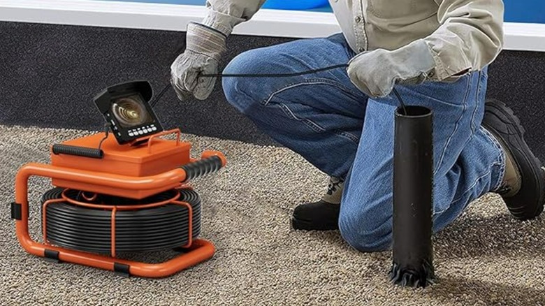 A person using an ESANHAO drain camera
