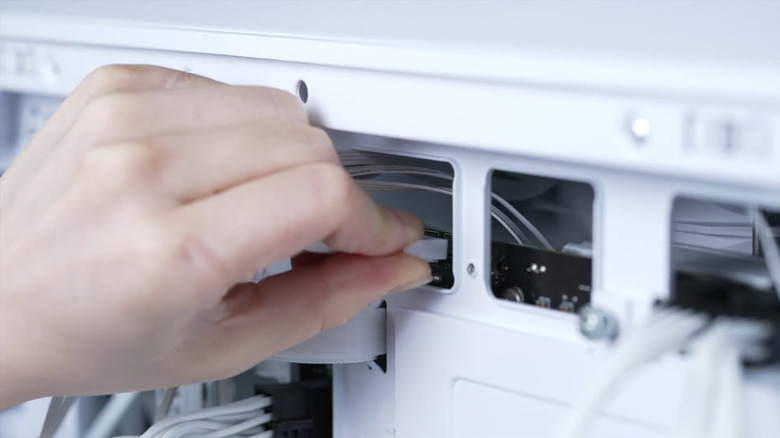 Someone plugs something into a desktop PC