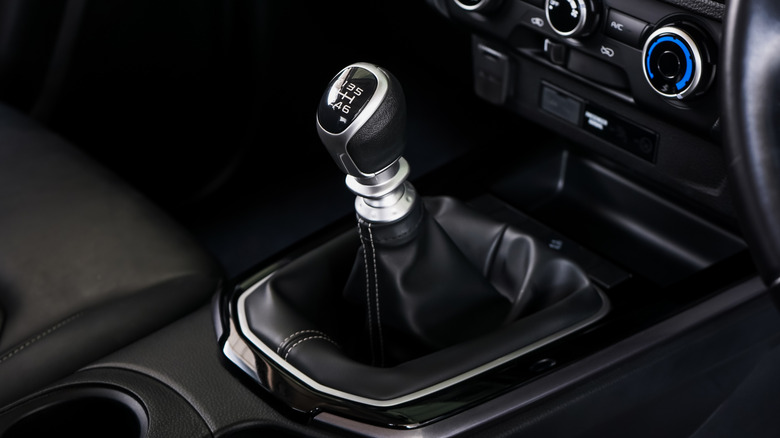 A manual gear shifter in a car interior