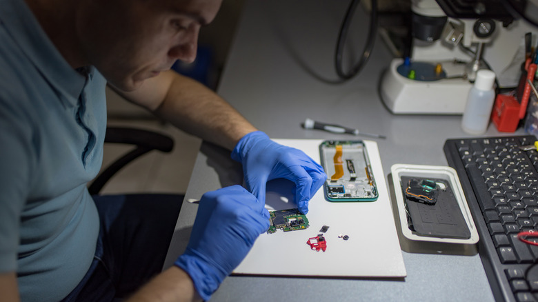 Person repairing smartphone