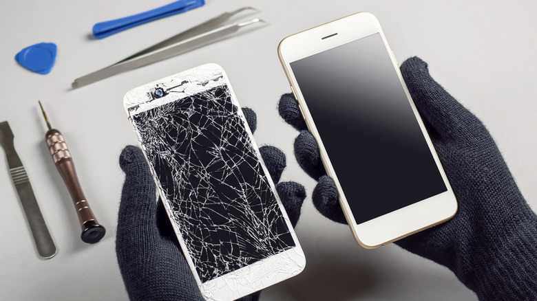 Person holding two smartphones