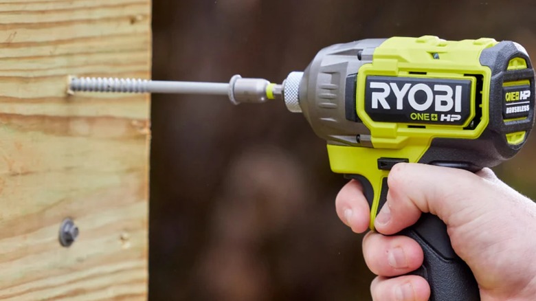 Using the Ryobi ONE+ HP Impact Driver on a wooden surface.