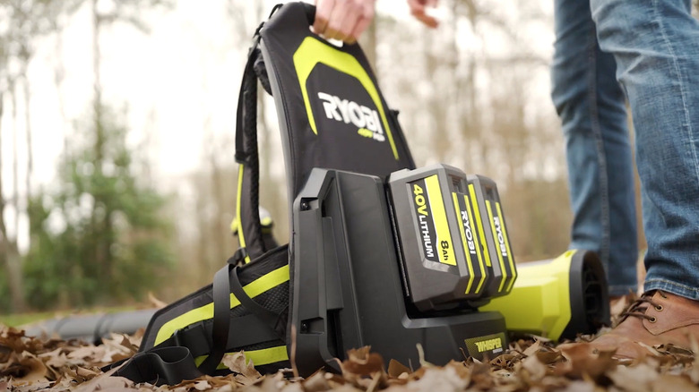 Person picking up Ryobi blower from the ground