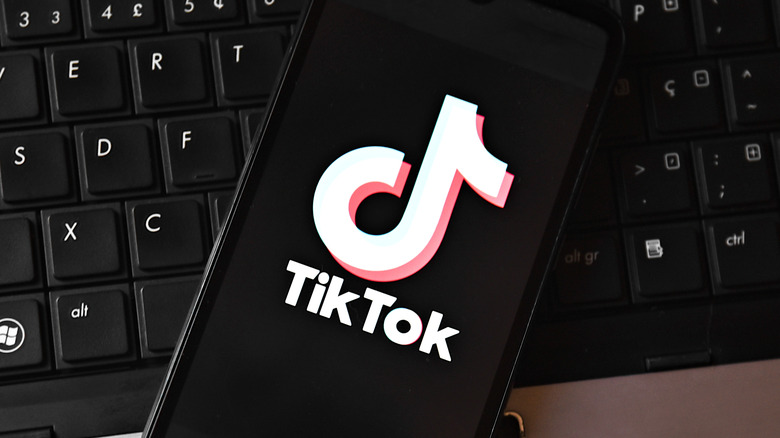 A phone displaying the TikTok logo.