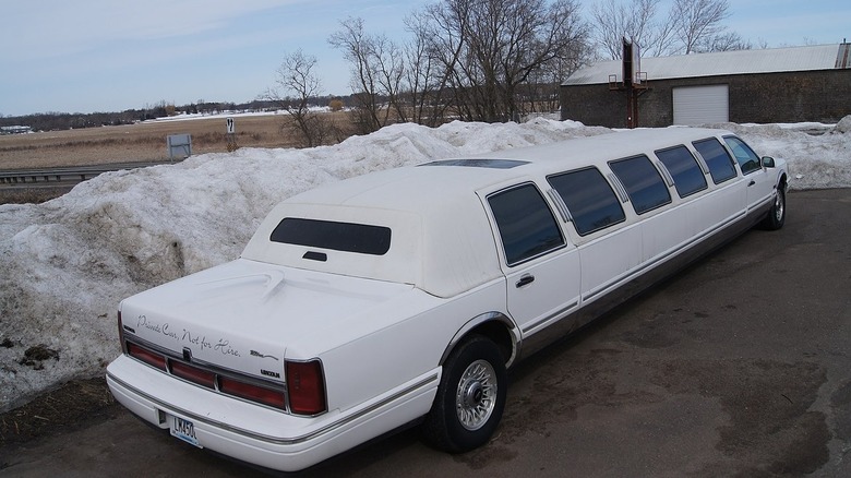 1997 Lincoln Town Car Limousine parked near snow drifts.