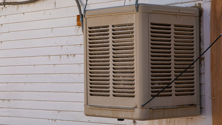 An evaporative "swamp" cooler mounted on a wall