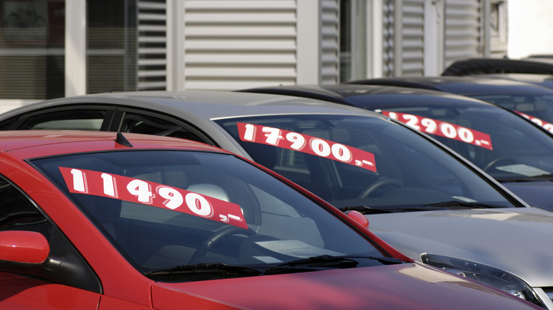 Close up of used cars with prices on their windshields