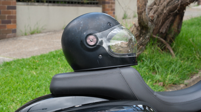 Black helmet on a parked motorcycle seat