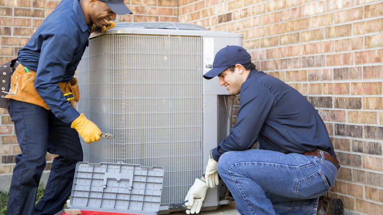 Air conditioner repair men at work