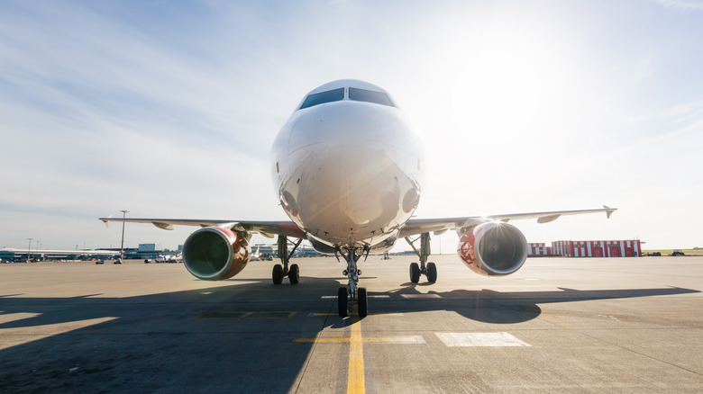 front view of an airplane taxiing down the runway