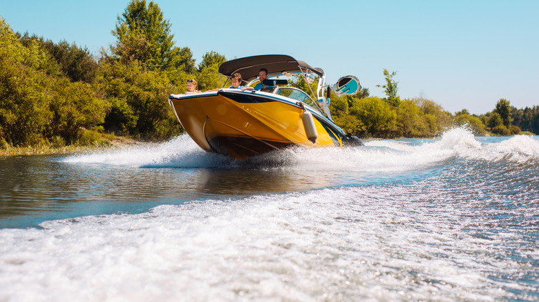 A young family enjoying a motorboat ride down the river