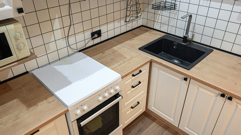 Kitchen corner with a sink and an outlet on the wall
