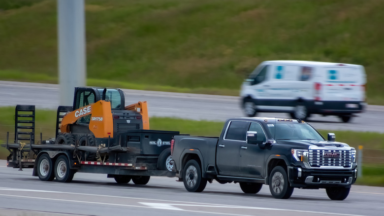 GMC towing a digger on a trailer