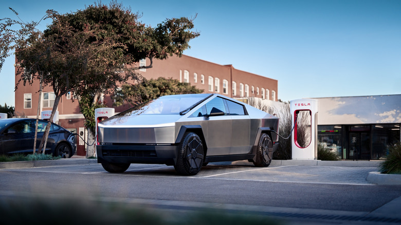 A Tesla CyberTruck being charged at a Tesla SuperCharging station
