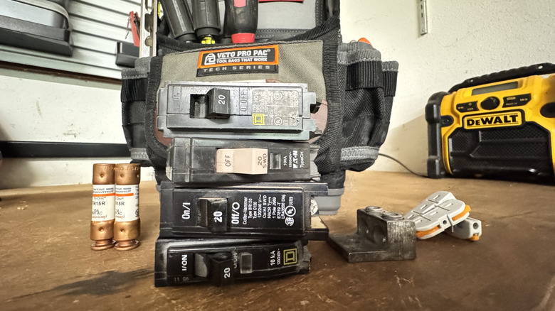A stack of single-pole, 20 amp breakers from different manufacturers