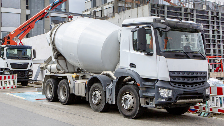 Large construction site, cement mixer and cranes