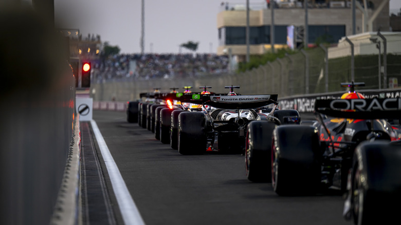 F1 cars lined up at a pit lane red light