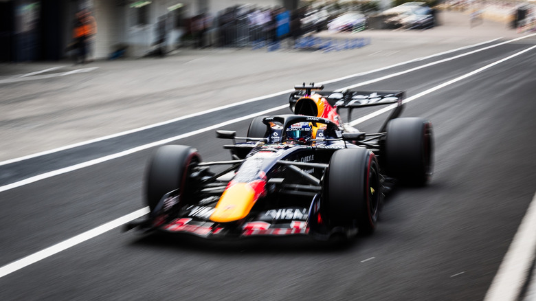 F1 car driving in pit lane