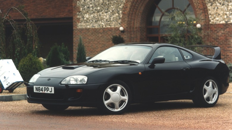 1993 Toyota Supra parked in front of European classic building, front-left 3/4 view