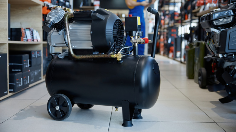 An air compressor positioned on the floor of a store