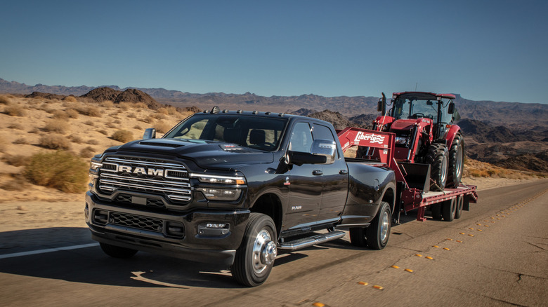 Image of a 2025 Ram 3500 HD towing a digger