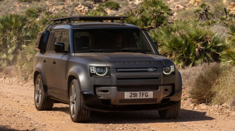 Black Land Rover Defender off-roading