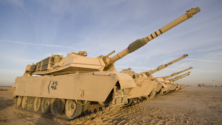 A row of tanks with turrets raised, each displaying the "bulge" known as a bore extractor or fume evacuator.