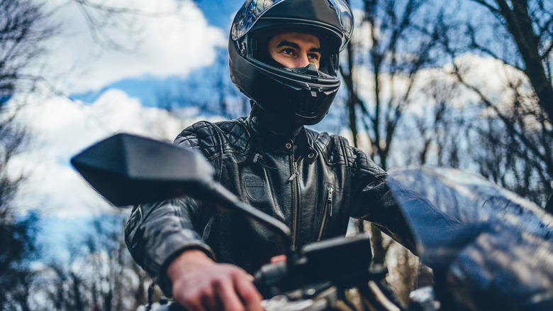 Young man with helmet riding a motorbike