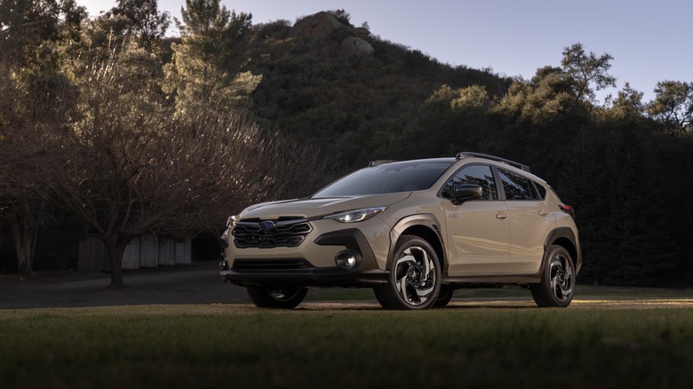 Gray 2026 Subaru Crosstrek Hybrid parked in a field