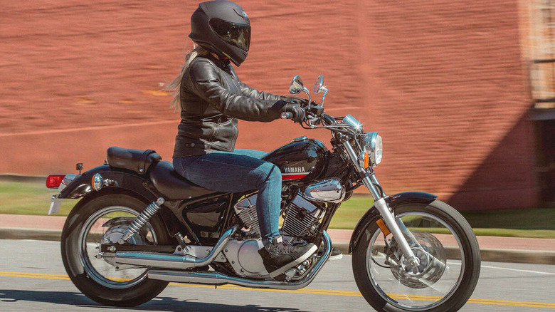 A lady driving a Yamaha V Star 250