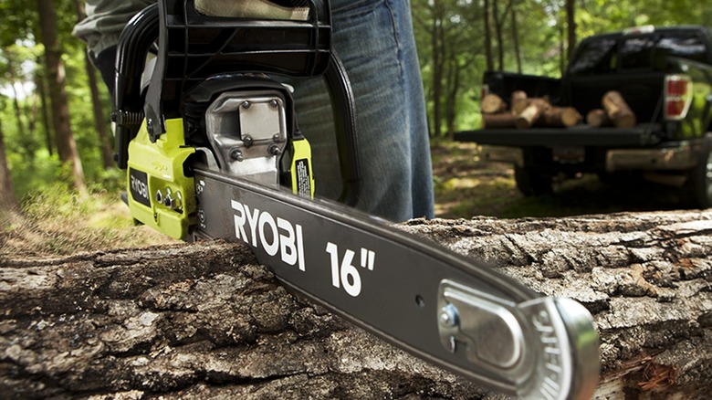 Person cutting log with Ryobi chainsaw