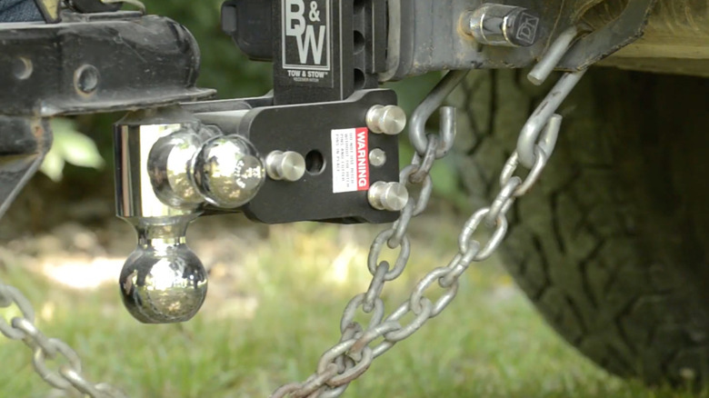 close up view of trailer chains hooked up to a tow car
