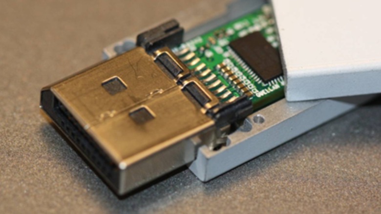 A close up shot of an active DisplayPort cable, showing the circuitry inside the connector
