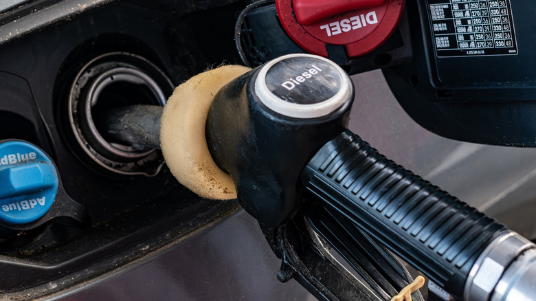 Refueling a modern car with diesel fuel at a gas station