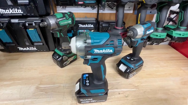 Several cordless impact wrenches on a table