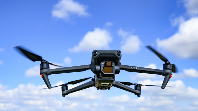 DJI Mavic 3 drone flying in the air with the Hasselblad gimbal camera pointing forward.