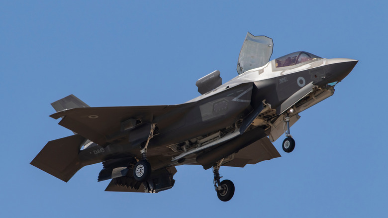 An F-35B in the air with the lid open