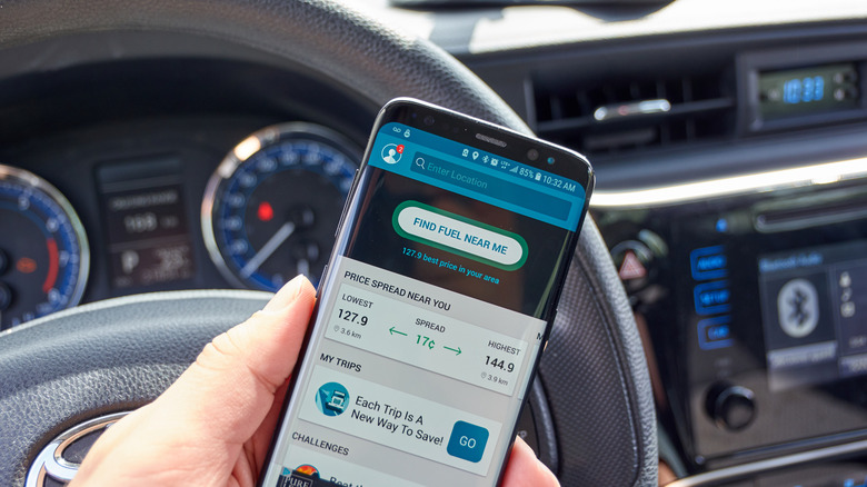 Person using GasBuddy app to find fuel in their area