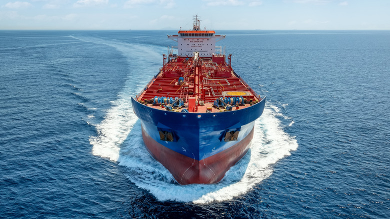 Aerial front view of a heavy crude oil tanker traveling with speed over the ocean