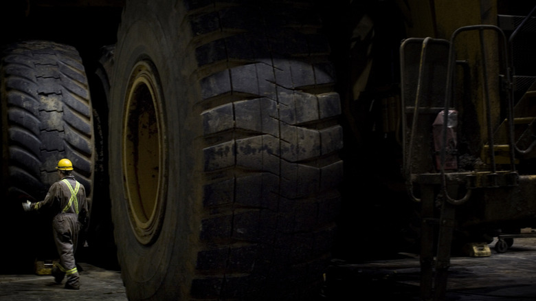A close up of the XDR 59/80R63 tire on a Caterpillar 797