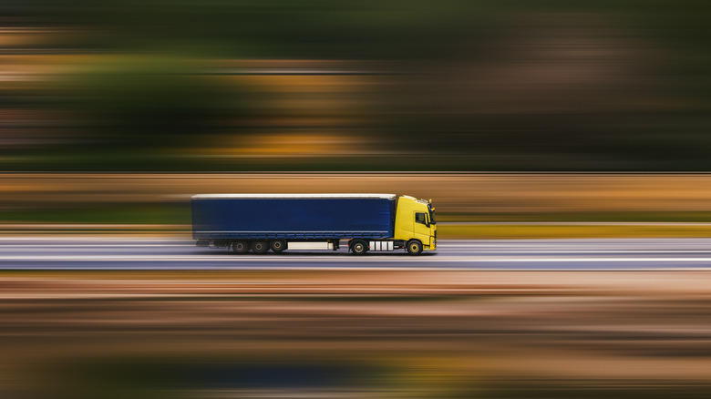 Semi truck moving rapidly down freeway