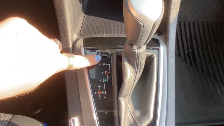 demonstrating how to use the shift lock release feature in a Toyota vehicle