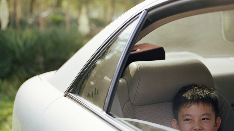 A car's quarter window beside an open window.