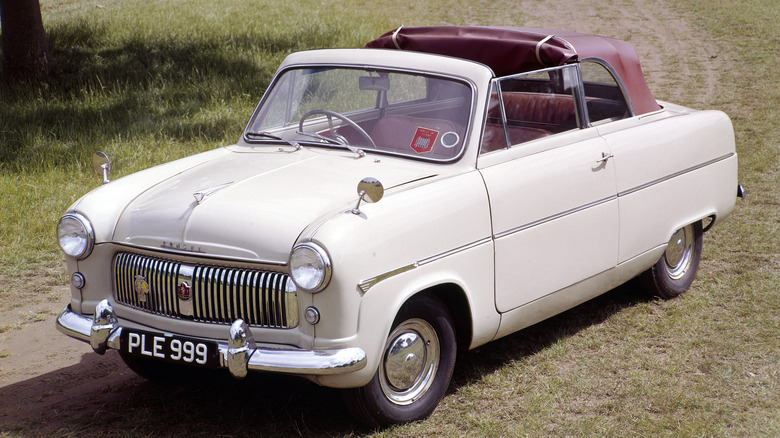 A 1955 Ford Consul Convertible Mk1 on a field, front 3/4 view, white exterior