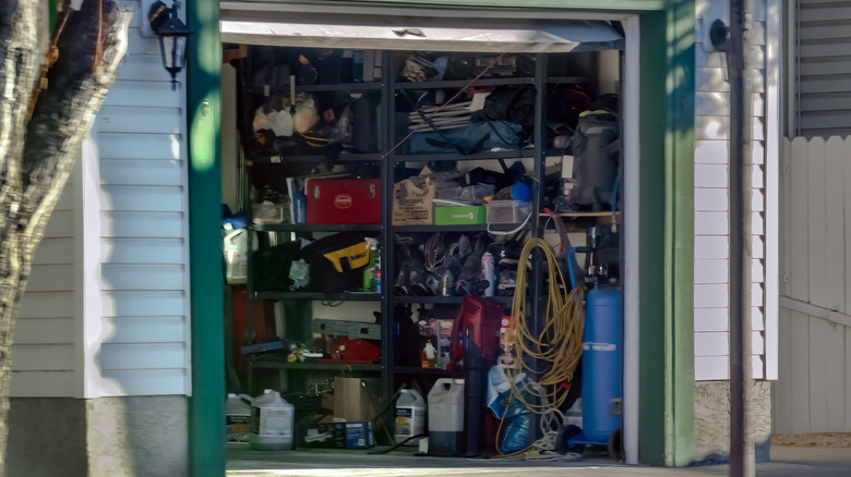 Cluttered garage with door open