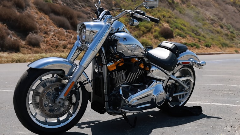 A close up shot of a Harley-Davidson Fat Boy parked in an empty parking lot.